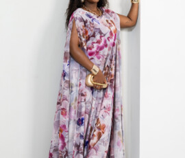 A statement silhouette featuring unique slit sleeve detailing. Side view of a floor-length floral kaftan with slit sleeves and gold accessories by K&R Thread.