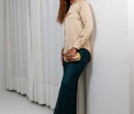A masterclass in textural contrast featuring fluid satin and intricate lace. Champagne satin button-down blouse paired with emerald green lace trousers from K&R Thread.