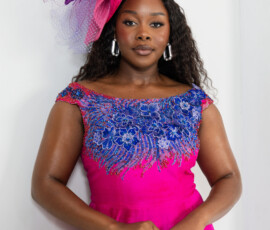 Exquisite craftsmanship meets vibrant color for your most memorable occasions. Fuchsia pink gown with intricate blue floral beading and a matching feather fascinator by K&R Thread.