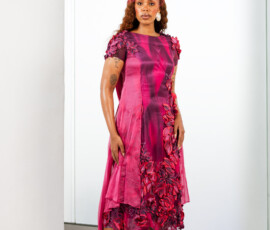 The perfect tea-length silhouette for your next garden party. Full length view of a plum and magenta mesh midi dress with floral embroidery and purple lace-up heels from K&R Thread.